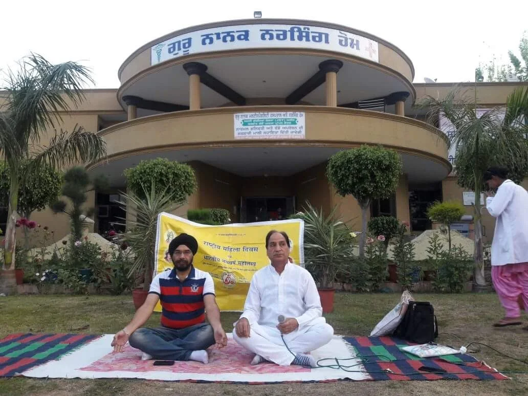 Dr. Bhupinder Arora practicing yoga at National Women's Day celebration