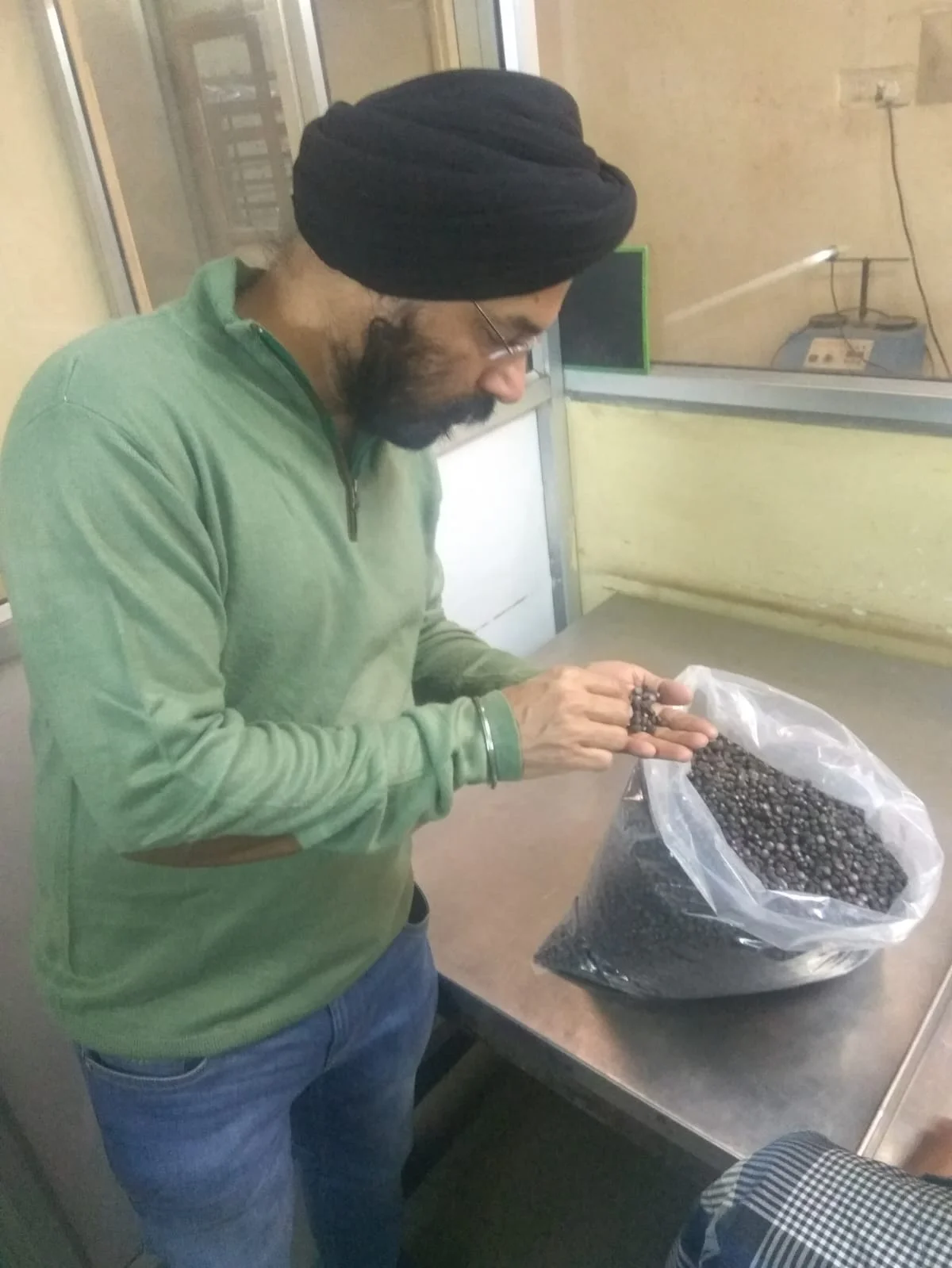 Dr. Bhupinder Arora examining raw materials used in the preparation of Ayurvedic medicine