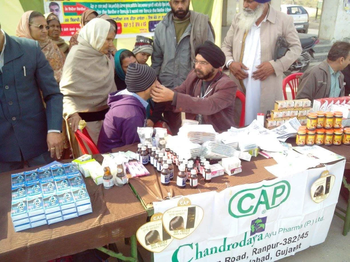 Dr. Bhupinder Arora examining a patient at the public service camp