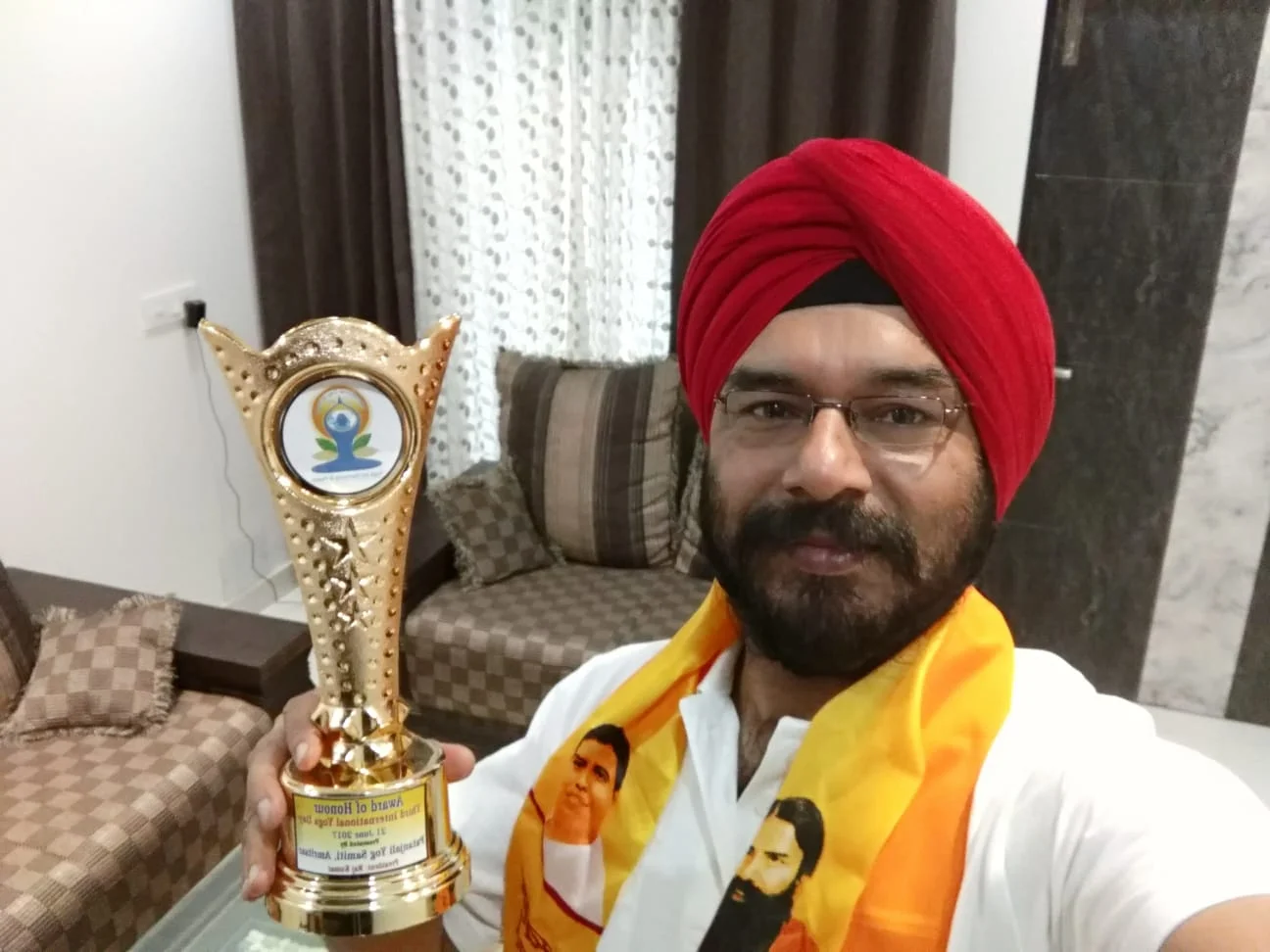 Dr. Bhupinder Arora holding an award of honor at a ceremony